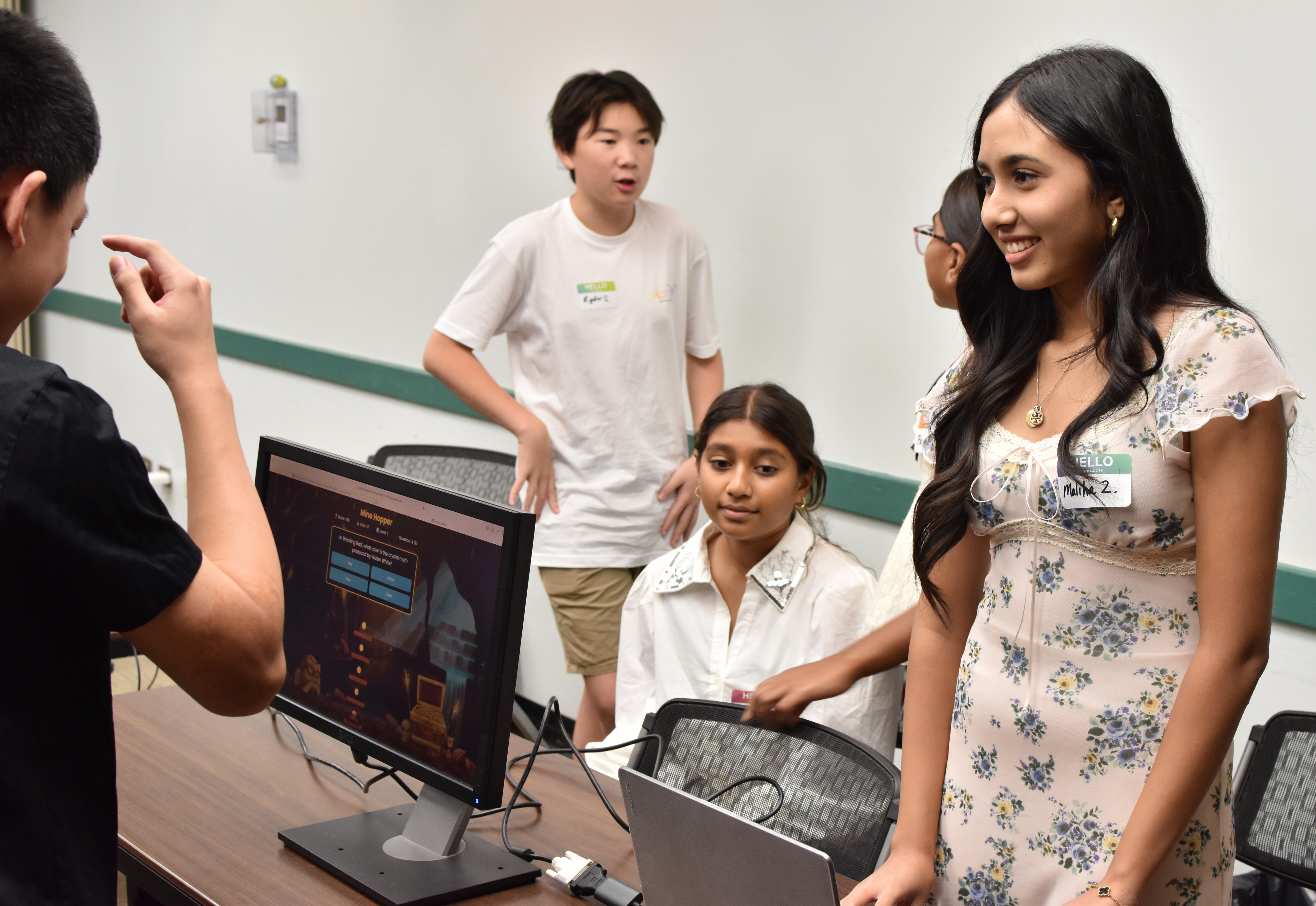 Students collaborating around a laptop
